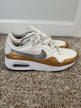 Nike White Sneakers with Silver Swoosh and Gold Accents